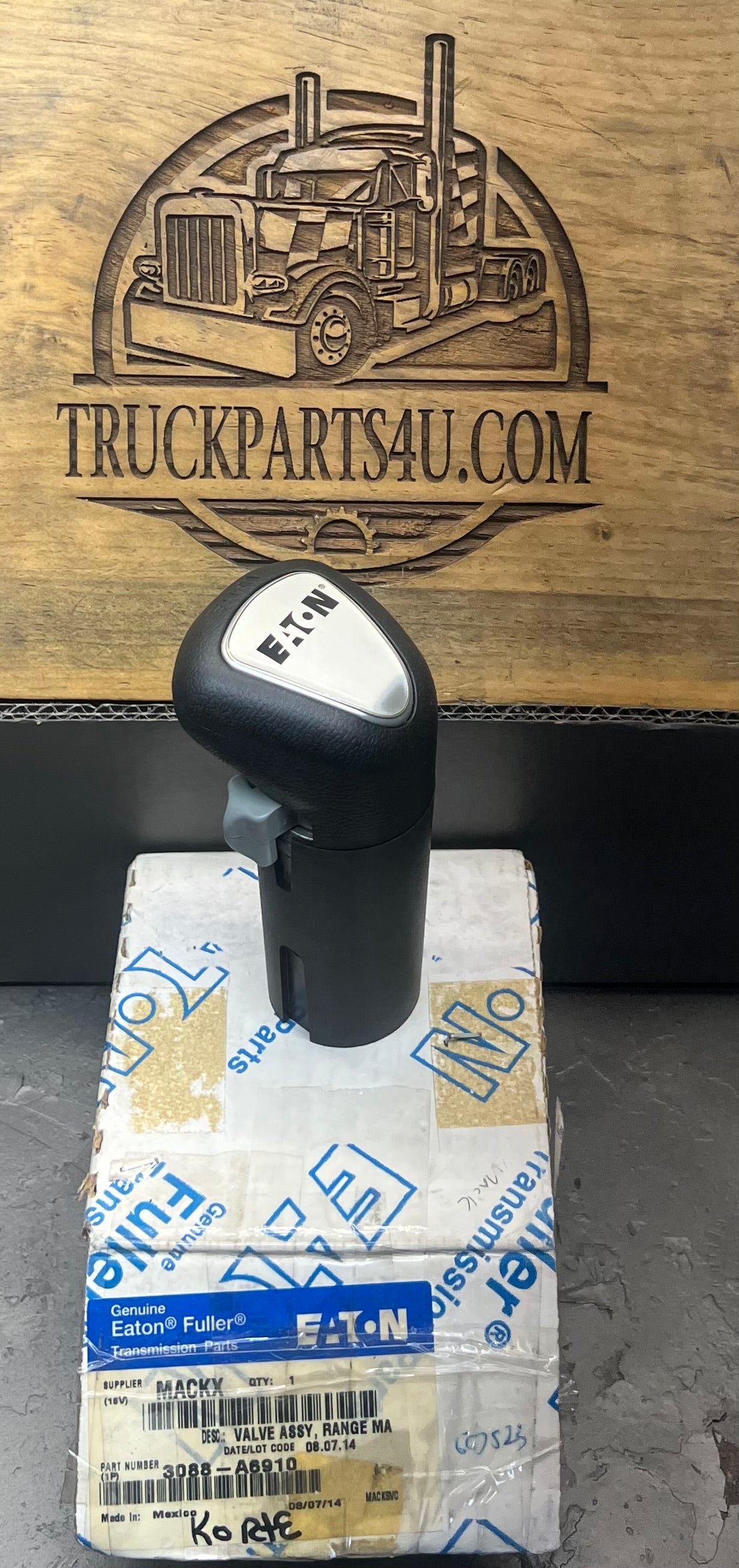 New Genuine Eaton Fuller A6910 pistol grip shift knob with gray forward/rearward thumb flipper installed on original packaging